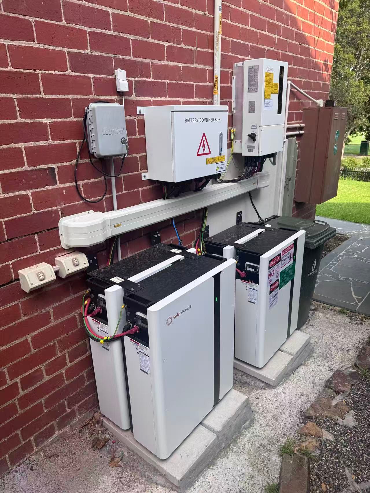Solis storage equipment and battery combiner hardware installed outside a brick property